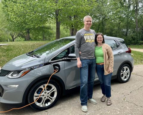 Aaron and Anna in front of Chevy Bolt