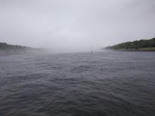 Sailboat entering fog in Cape Cod Canal