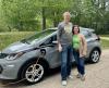 Aaron and Anna in front of Chevy Bolt